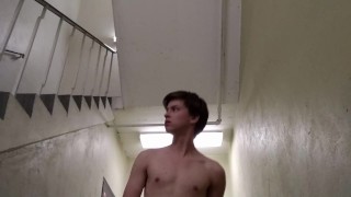 Solo teen plays with buttplug in the stairwell