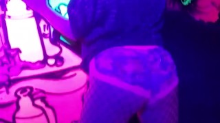 Sexy chick dancing, booty poppin in black light room.