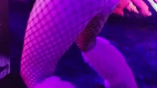 Sexy chick dancing, booty poppin in black light room.