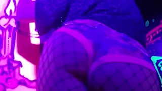Sexy chick dancing, booty poppin in black light room.