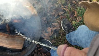 Putting out a fire at the campsite by pissing on it