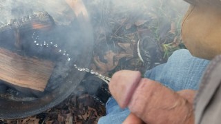 Putting out a fire at the campsite by pissing on it