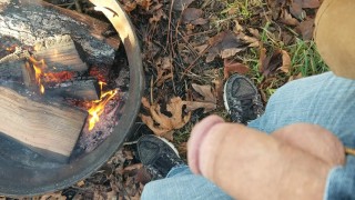 Putting out a fire at the campsite by pissing on it