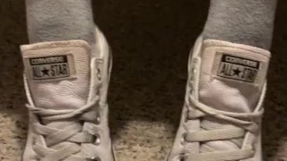 Ebony teen taking off sweaty shoes after class