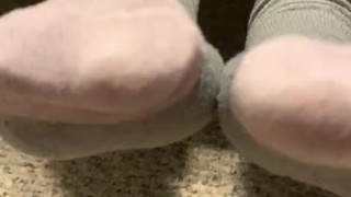 Ebony teen taking off sweaty shoes after class
