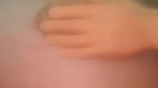 Tiny hand playing with nipple