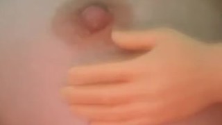 Tiny hand playing with nipple