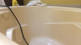 Taking in an enema in the bathtub