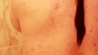 Long hair muscular man with piercing in the shower (vertical, 60fps)