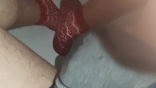 Wetting grey pants and red socks