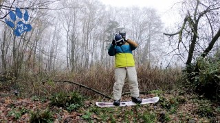 Snowboard pup pawing off outdoors