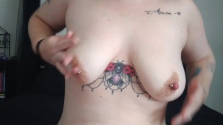 Tattooed girl plays with pierced boobies