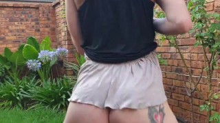 Girl pissing outside on the grass
