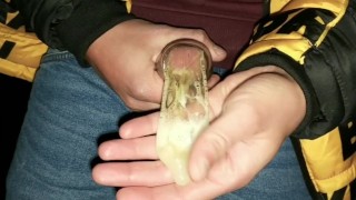 Twink fills cum filled condom even more public