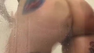 Tattooed hottie all wet in shower 