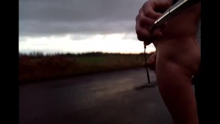 Flashing and wanking in the road with cars in distance 