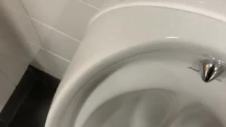 Having a risky wank in public toilets 