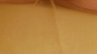 Peeing in the bathtub (back view)