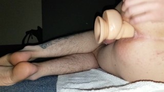 Skinny fucking his expanded anus with big dildo