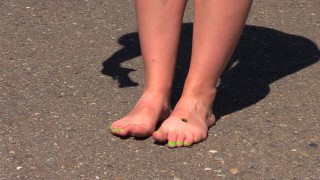 Bare feet on hot asphalt