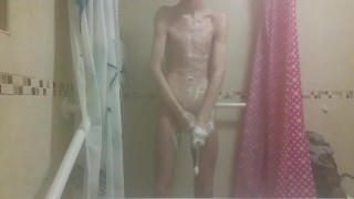 Hot very skinny guy with flat butt strokes his wet cock and pisses