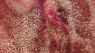 Soapy, wet pussy being played with in a bubble bath. 
