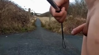 Naked with and without penis pump at side of busy road