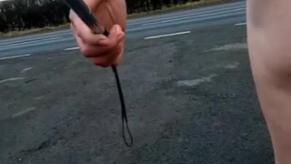 Naked with and without penis pump at side of busy road