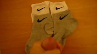 Jerk off and cum over four Nike socks
