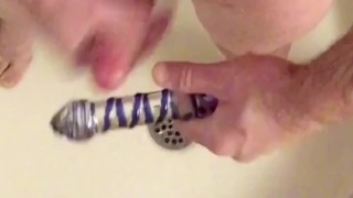 Foreskin docking/stroking using glass dildo then cum on dildo & suck clean.
