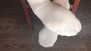 STUDENT GIRL SHOWS WHITE SOCKS AND FEET AFTER STUDYING.
