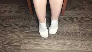 STUDENT GIRL SHOWS WHITE SOCKS AND FEET AFTER STUDYING.