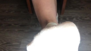 STUDENT GIRL SHOWS WHITE SOCKS AND FEET AFTER STUDYING.