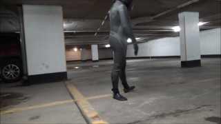 wetsuited & masked in parking garage