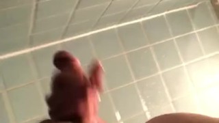 Stroking semi hard cock in the dorm shower