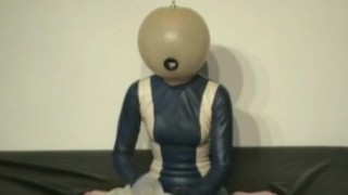 Girl With Transparent Latex Ballhood And Rubber Sheet Makes Breath Play