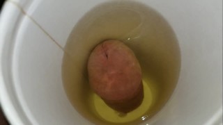 pissing in a cup from the bottom and letting it drip down my balls