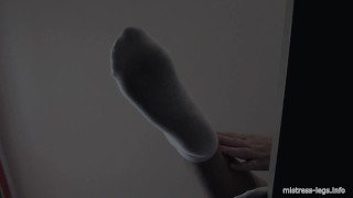 Legs in white socks on the table