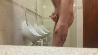 Very skinny teen masturbates in public bathroom urinal