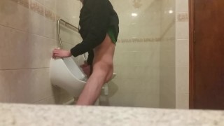 Very skinny teen masturbates in public bathroom urinal