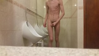 Very skinny teen masturbates in public bathroom urinal