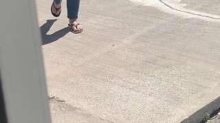 Female friend feet in flip flops coming to see me in public, in motion view