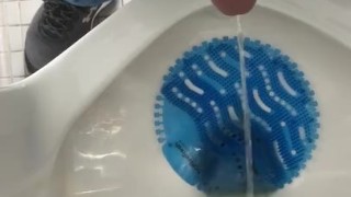 Pissing at a urinal. 