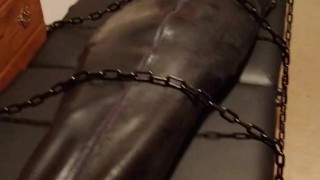 Hairless rubber gimp plugged and in chastity, training