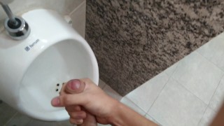 Cumming at public urinal