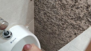 Cumming at public urinal
