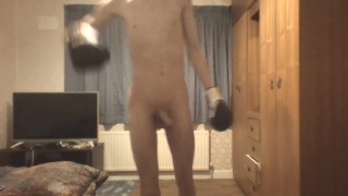 Skinny twink in boxing gloves does shadow boxing and shows off his ribs