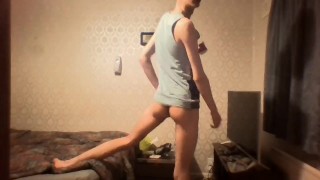 Very skinny twink with a cap strokes his cock while wearing a tank top