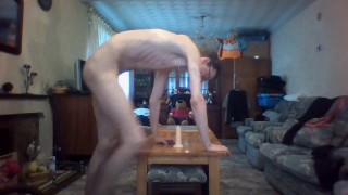 Skinny teen rides a dildo deep in his anus in living room and moans