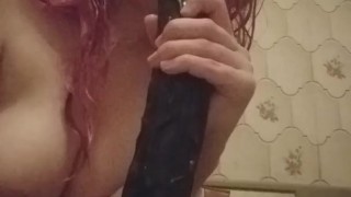 Slutty bitch in bath sucks and cleans dildo with her tongue and mouth